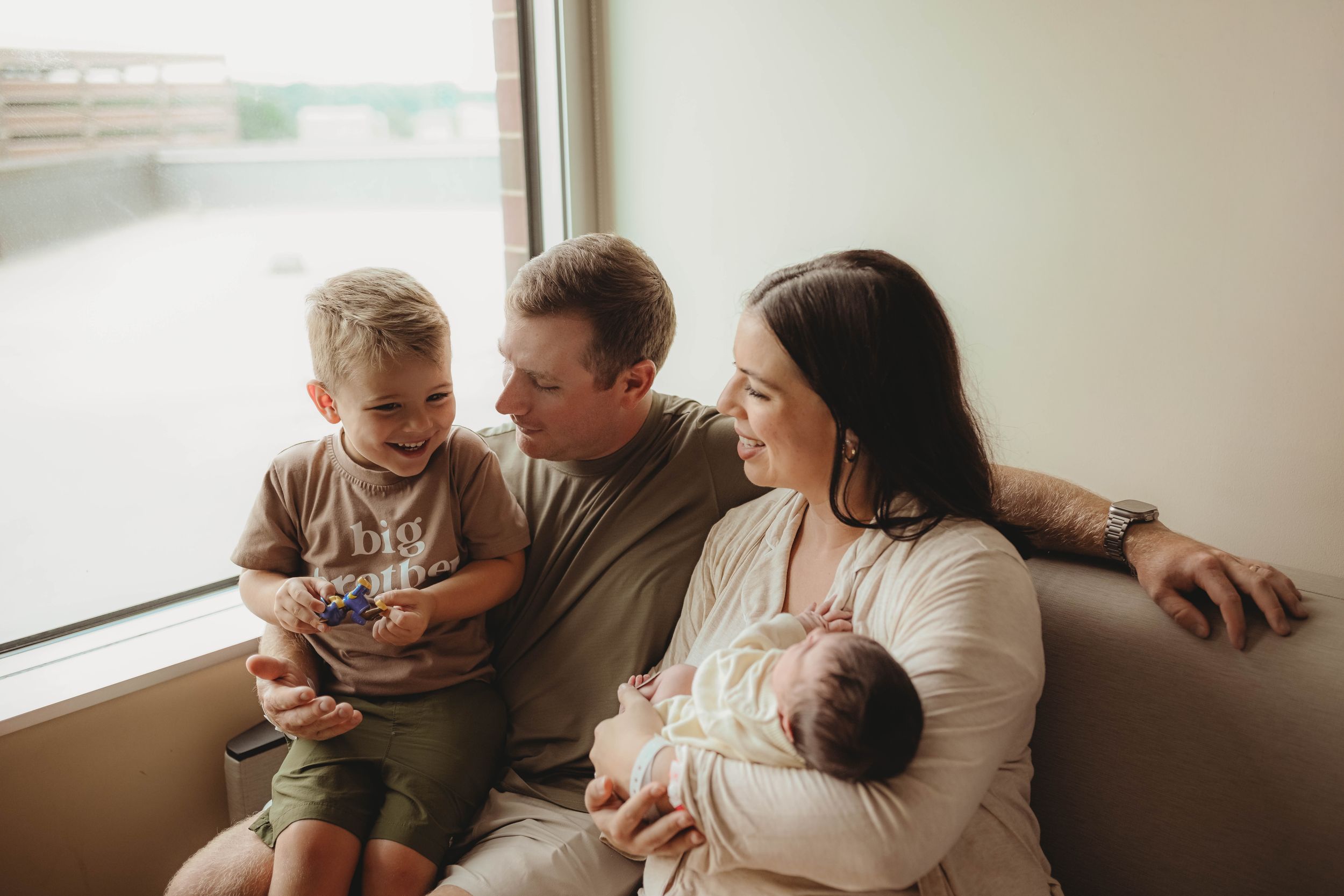 Family gathering on couch sharing intimate moments in warm natural light.