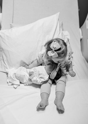 Newborn photography session with baby lying on white backdrop in various poses.