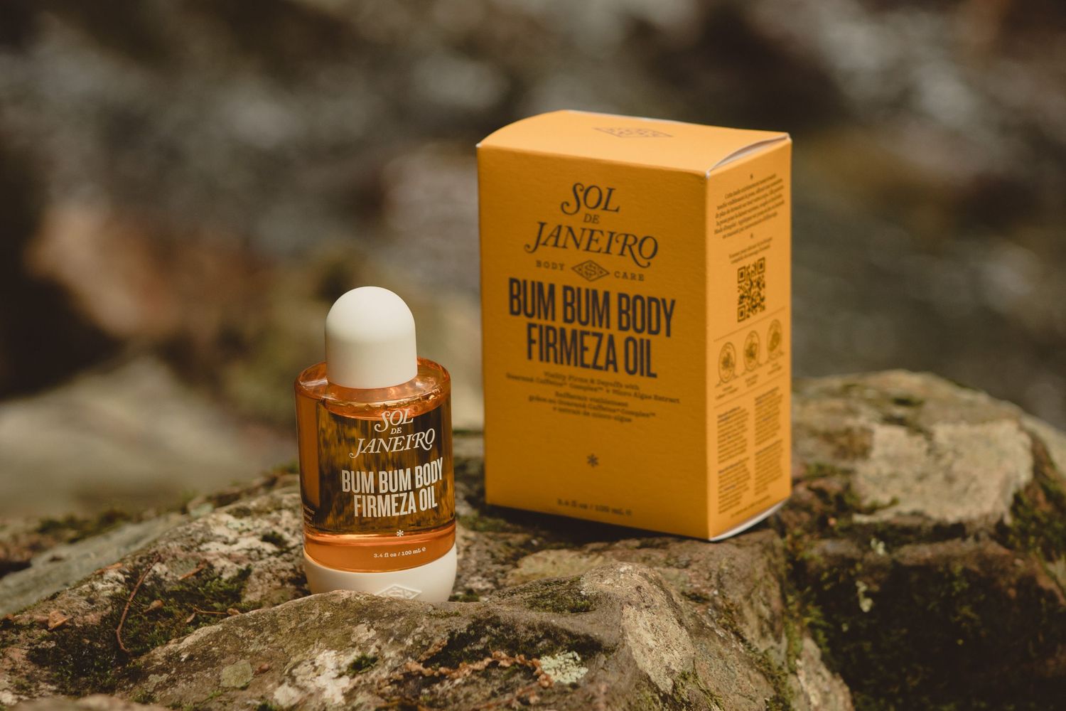 Outdoor product photography, body oil, sol de janeiro, rocks, moss, water, river, brand, branding, warm, moody, products