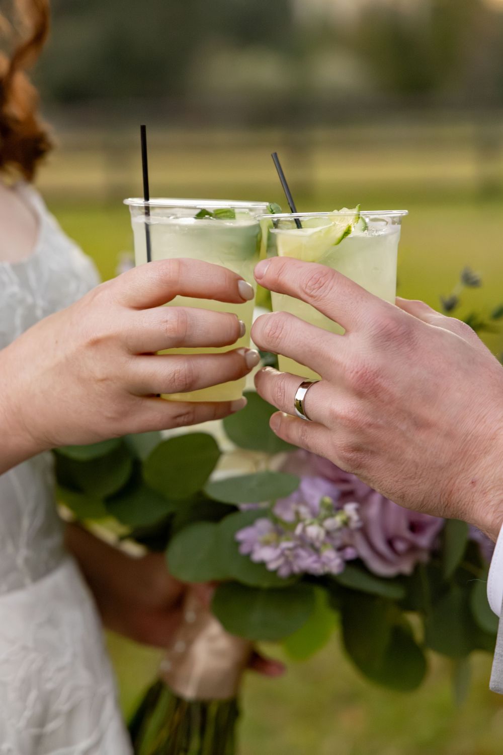 Close-up sequence of hands exchanging rings during an outdoor wedding ceremony.