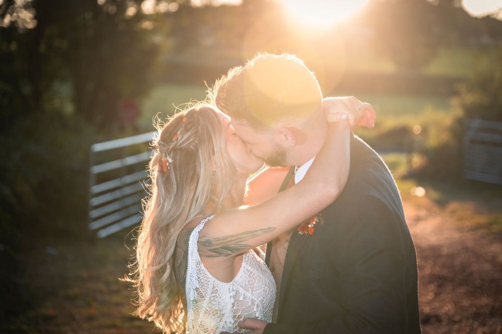 Bride and Groom kissing at sunset, Sherwood Glades Wedding Venue