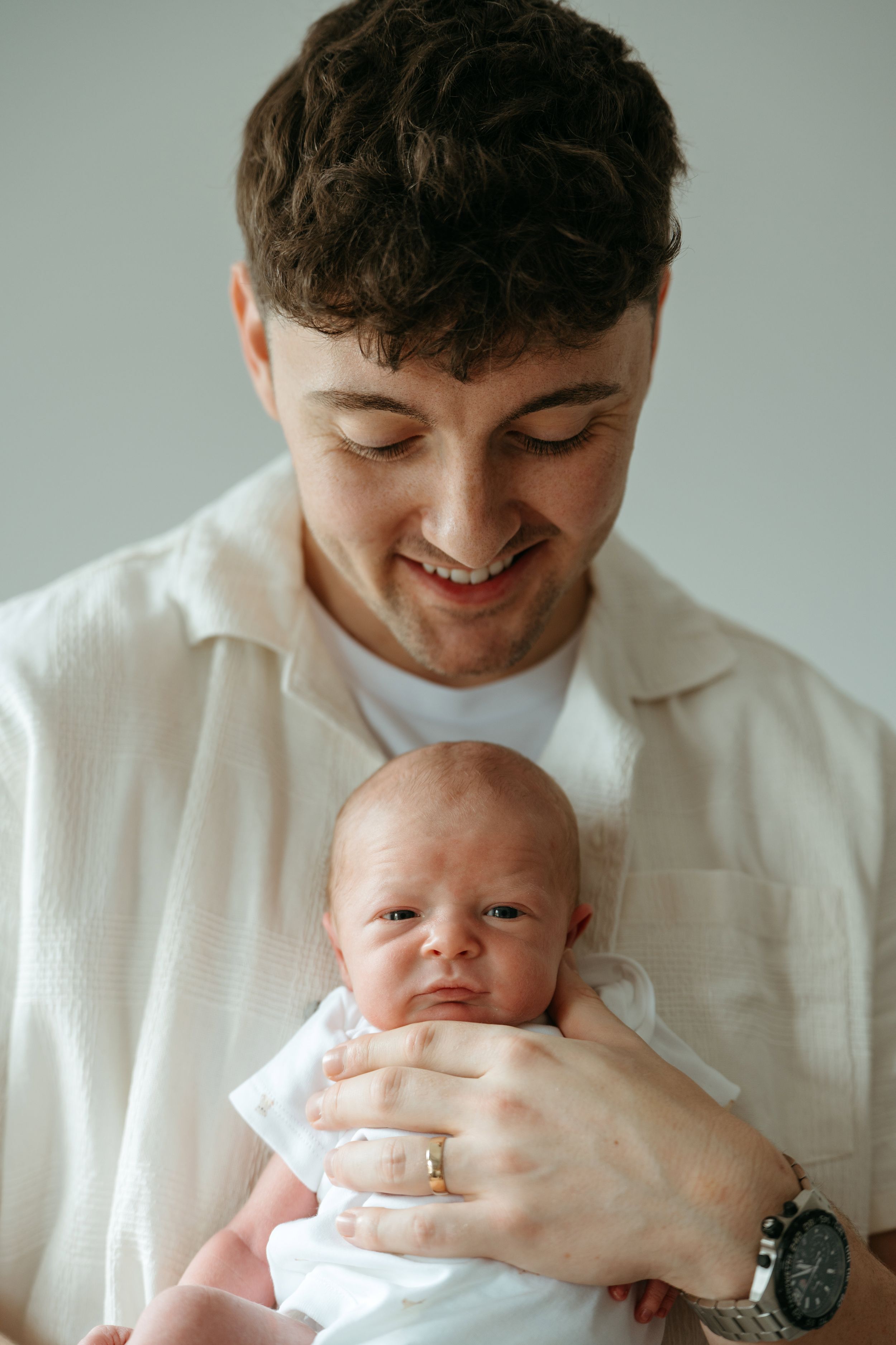 Close-up shots showing tender moments with a newborn baby.