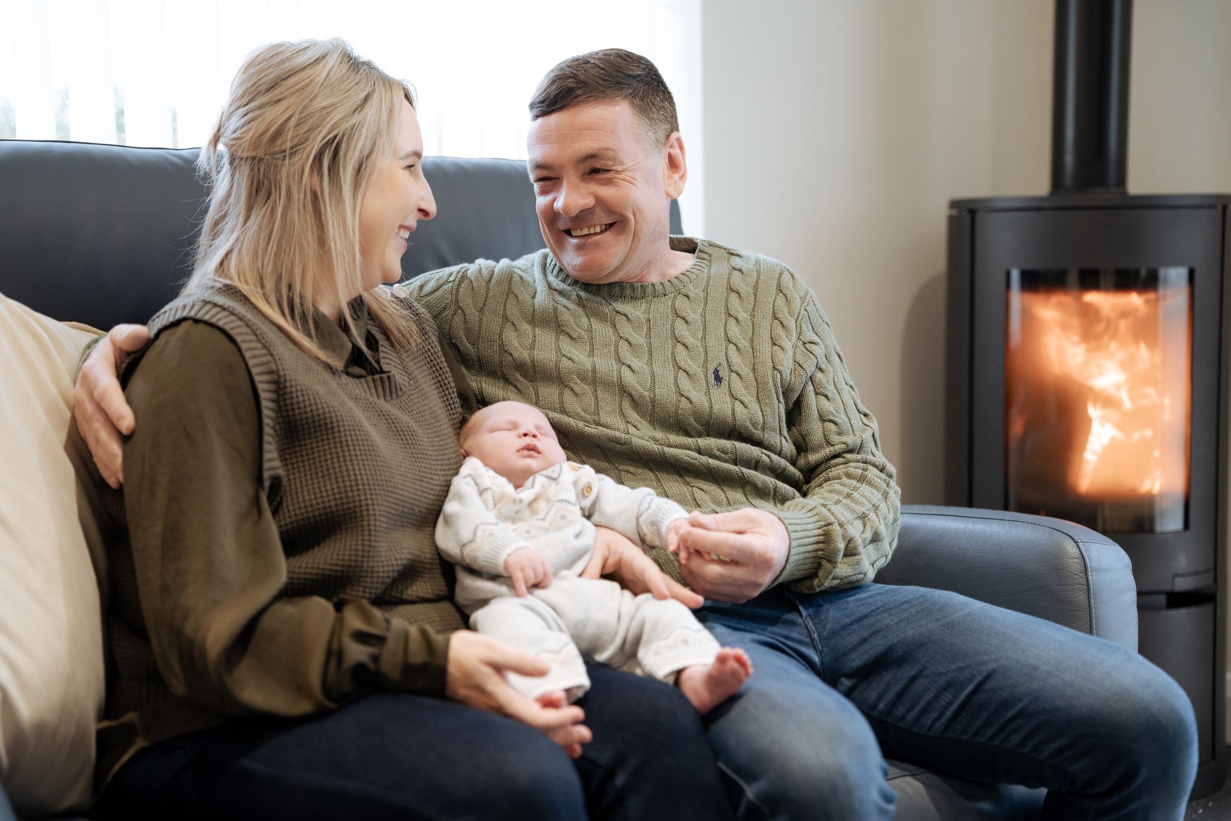 A cozy living room scene with people relaxing on a comfortable sofa.