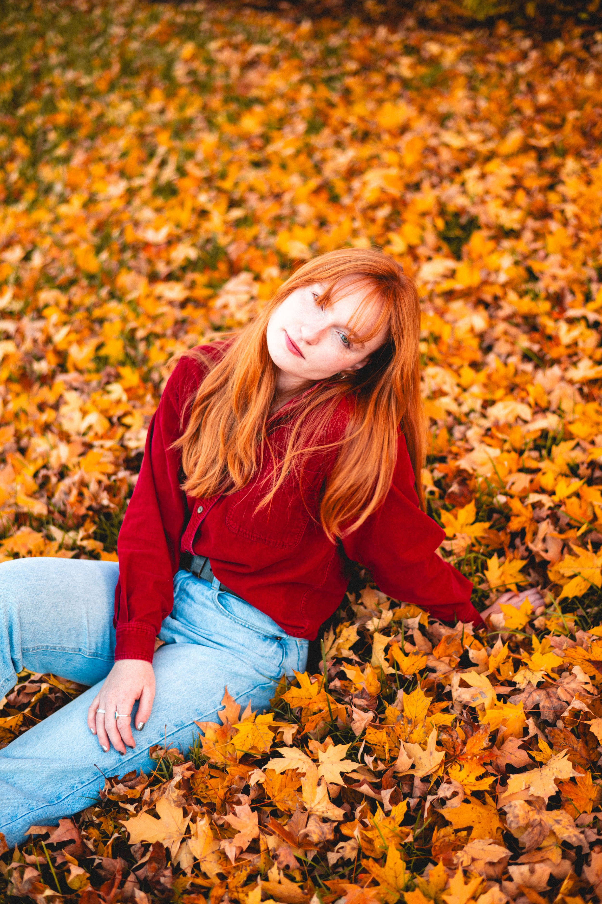 Portrait of a red haired girl in the fall