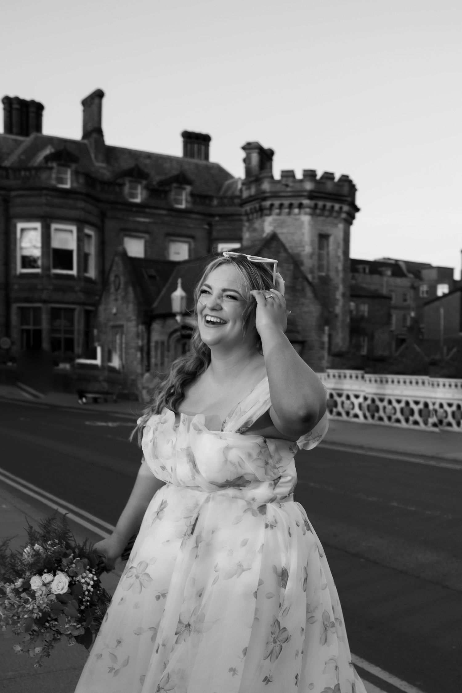 black and white image of bride on the York bride smiling during sunset hour