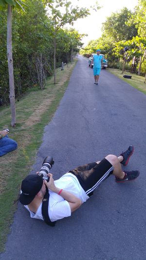Multiple images show someone lying on a paved path demonstrating proper core exercise form in an outdoor setting.