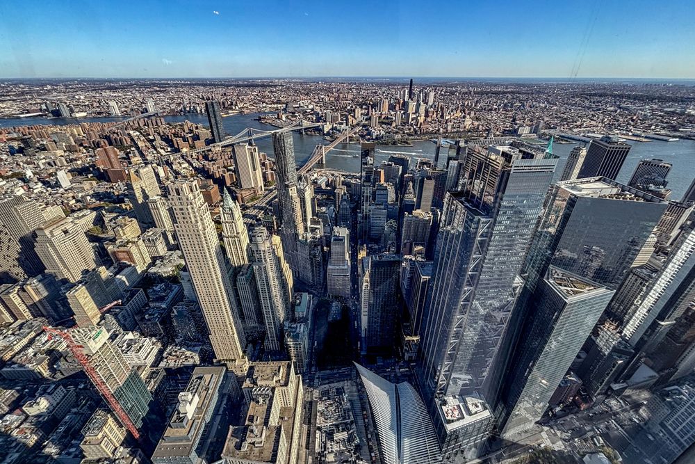 Aerial view of Manhattan skyline showing dense urban landscape of skyscrapers and waterfront.
