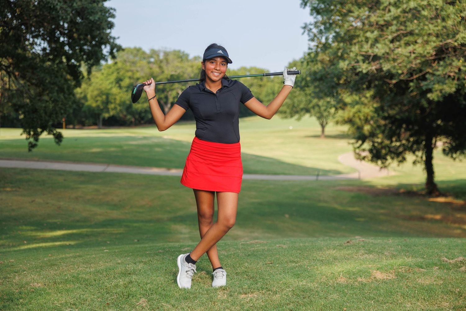 Athletic player in blue cap and shorts practices golf swing technique in sequence on sunny grass course.