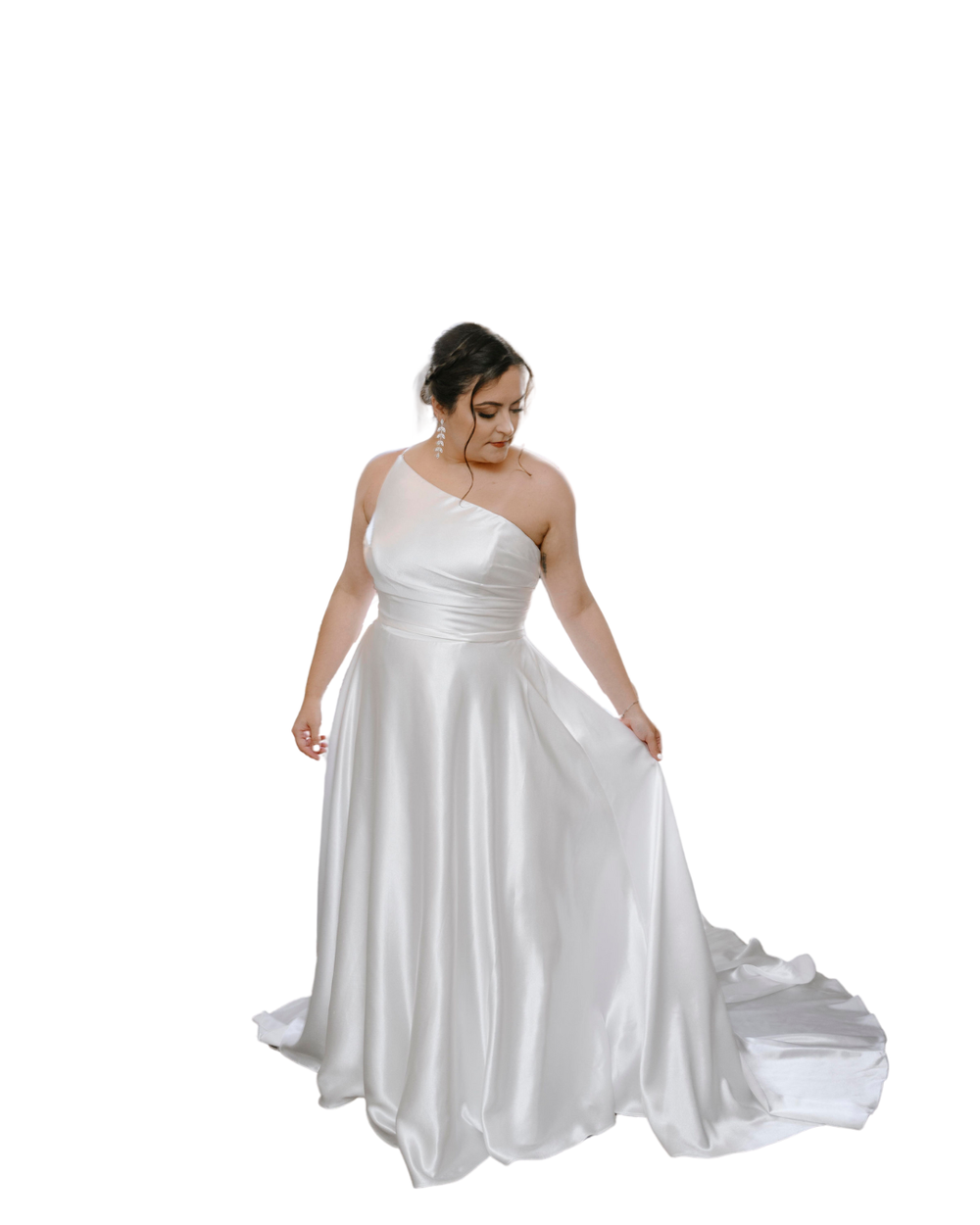 A person wearing a white one-shoulder satin wedding gown with a flowy skirt stands gracefully against a white background.