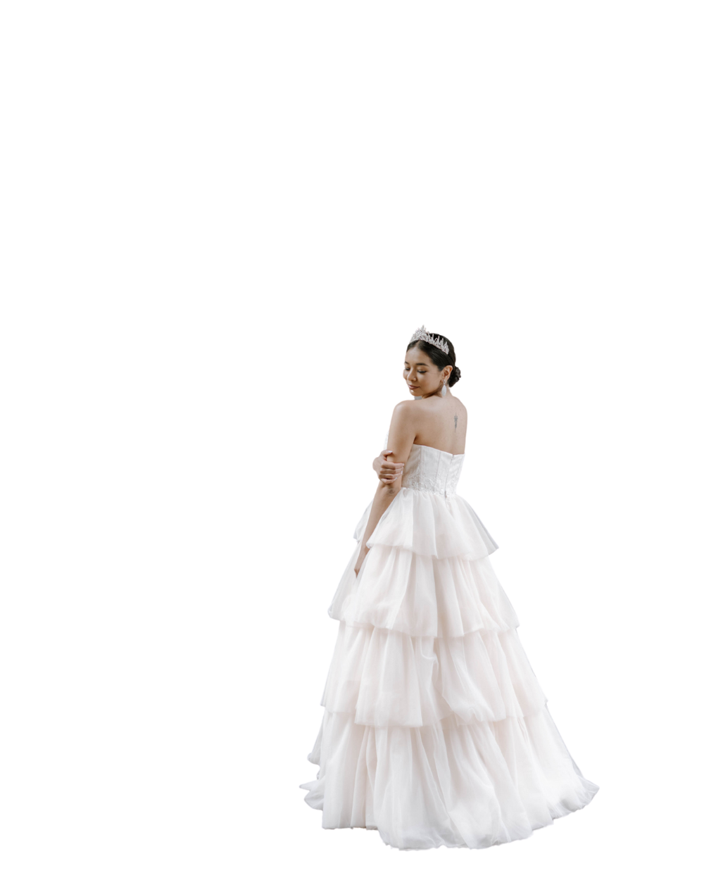 Elegant tiered white wedding gown with ruffled skirt and strapless bodice shown in profile view against white background.