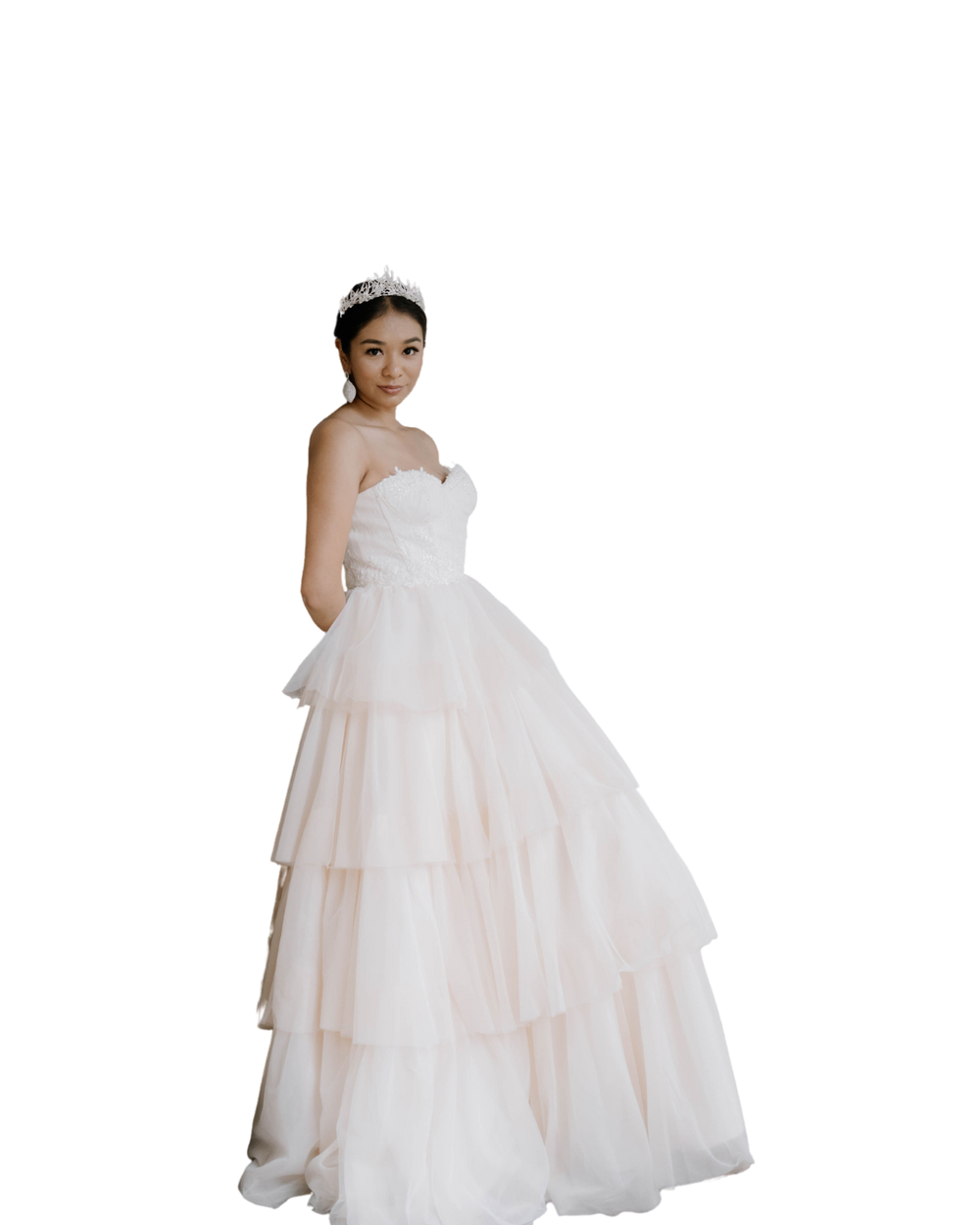 A layered tulle ball gown wedding dress with a strapless sweetheart neckline in white.