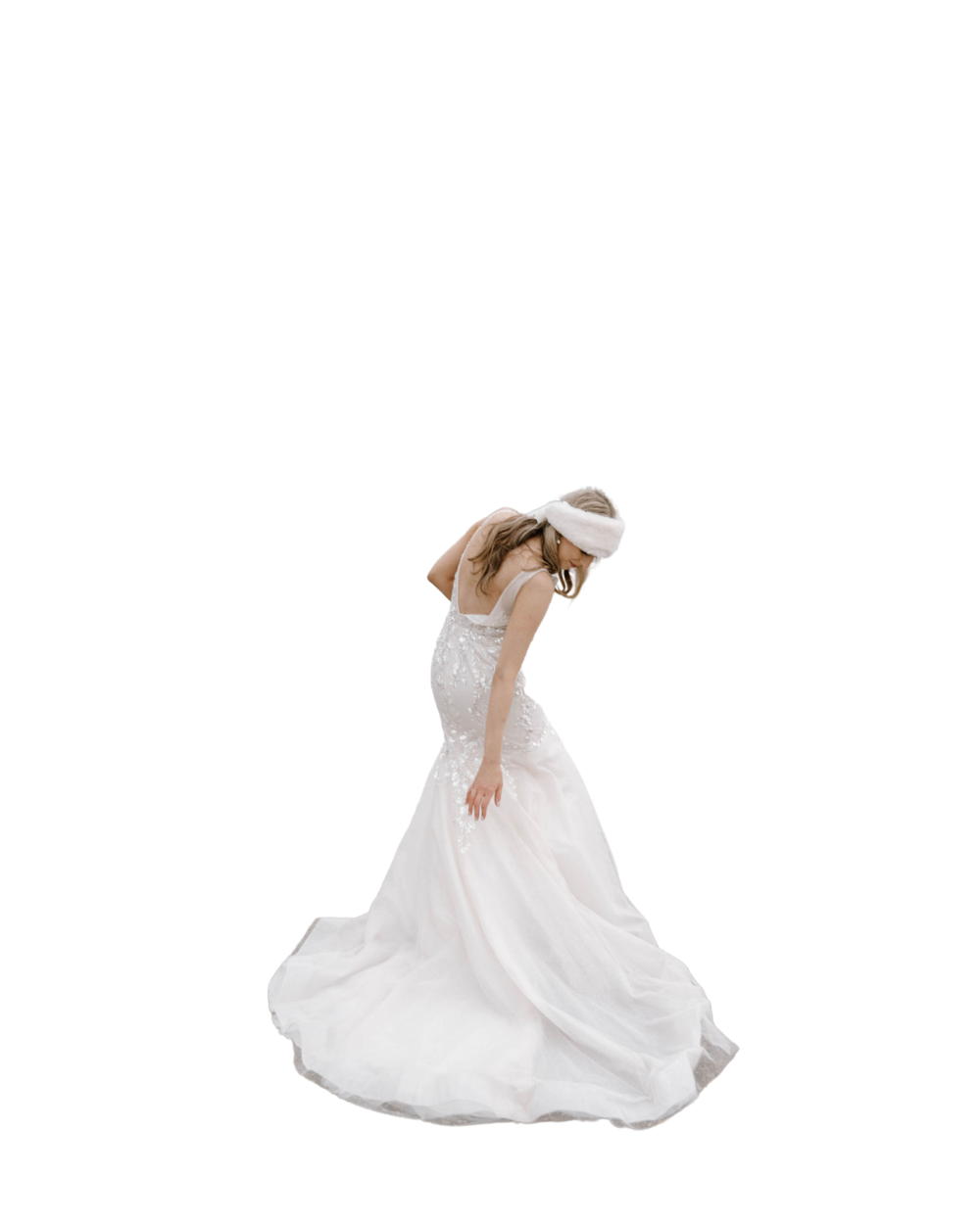A person in an elegant white wedding gown twirls gracefully, creating a flowing circular motion with the dress's fabric.
