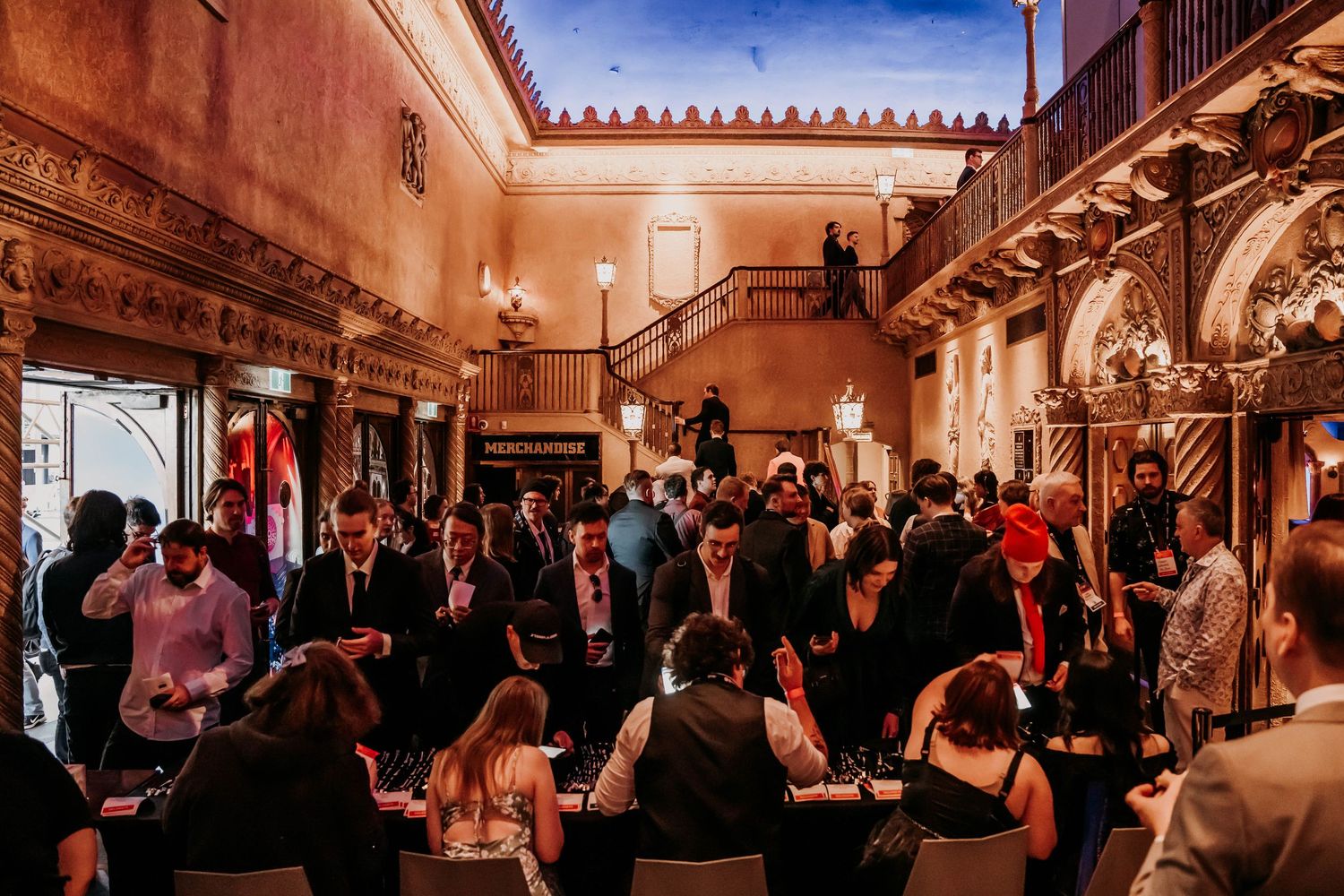 A cheerful dinner party scene with people gathered around a table with wine glasses sharing conversation and laughs.