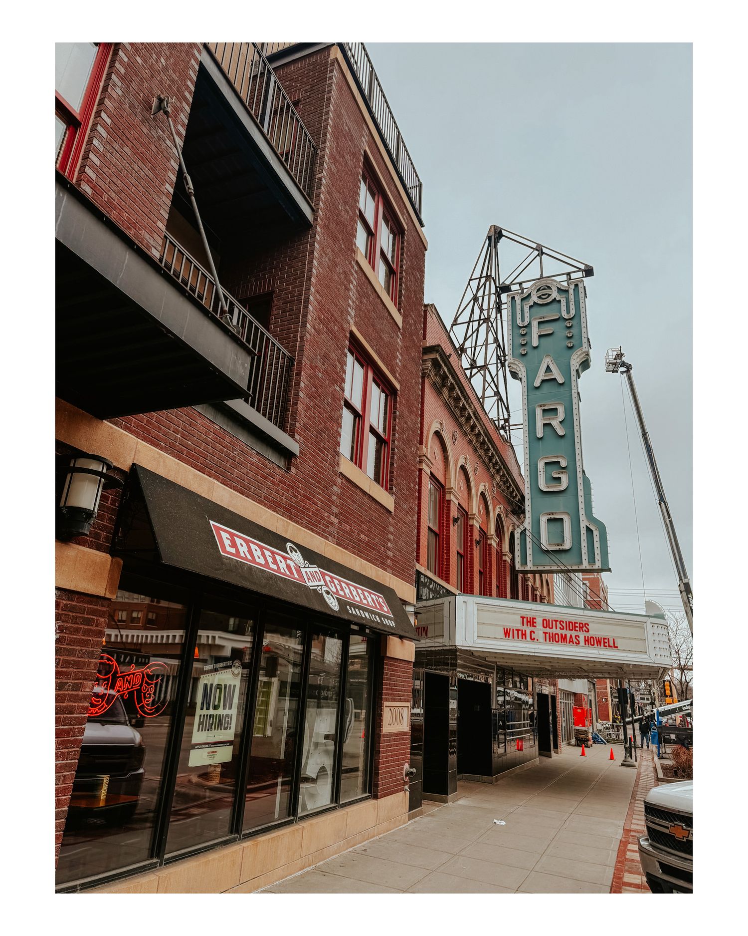 Historic Fargo Theatre marquee sign on red brick building facade in downtown area.