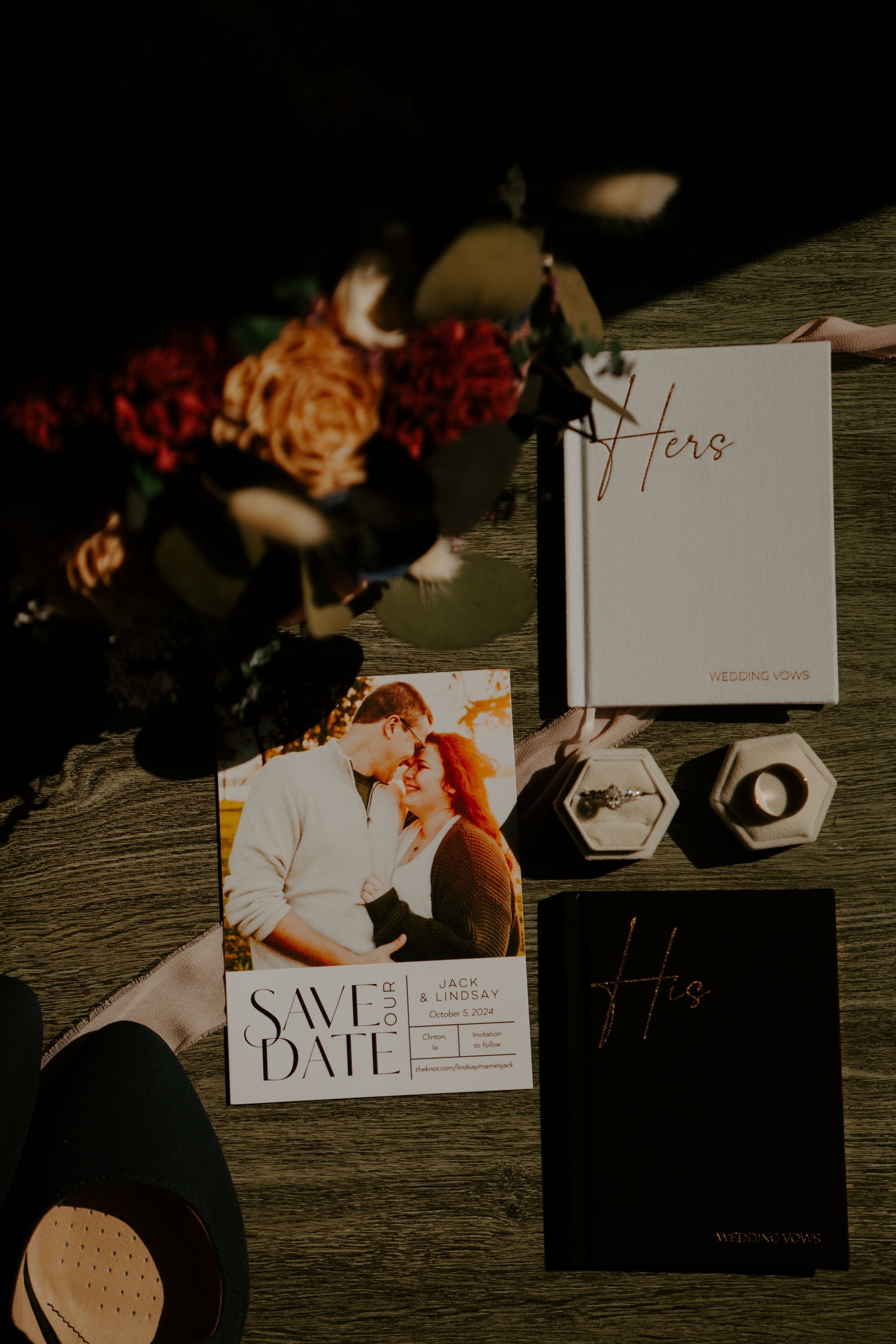Wedding stationery and save the date cards artistically arranged on a wooden surface.
