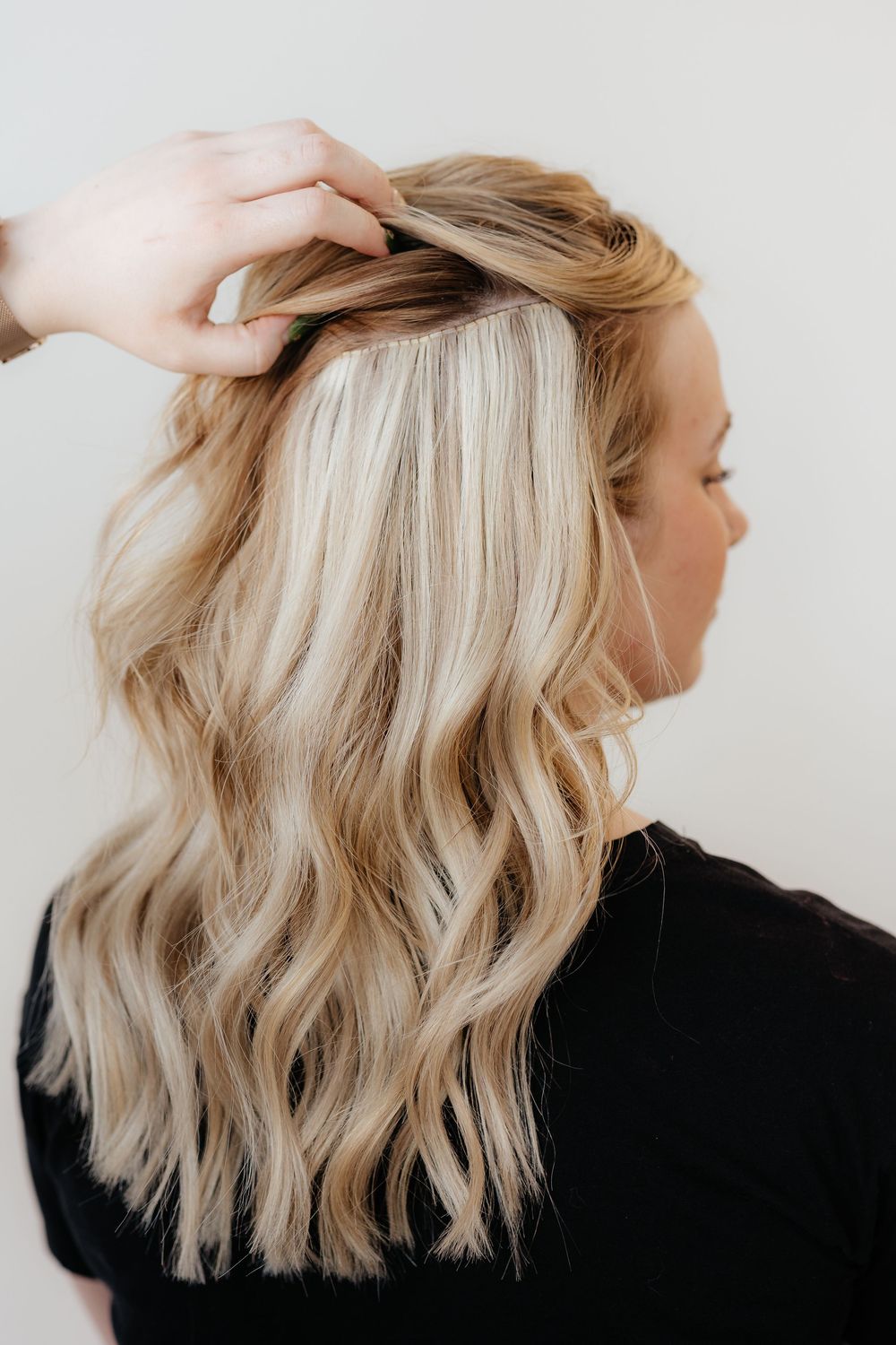 Four step progression showing how to style blonde wavy hair in a textured bob from different angles against white background.