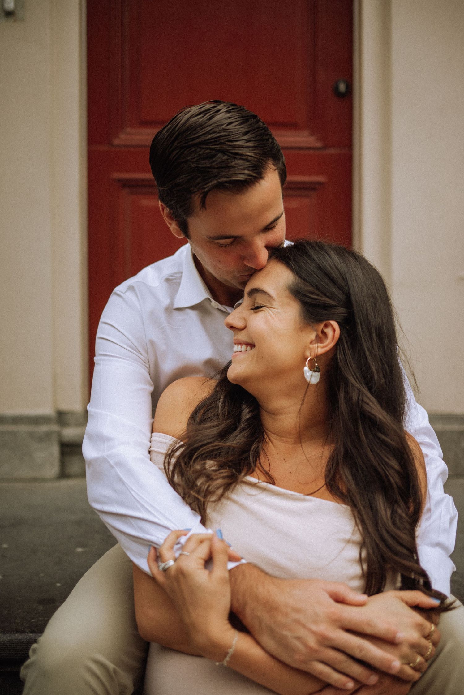Close-up lifestyle photo of a maternity photoshoot in Amsterdam with the man gently kissing the woman