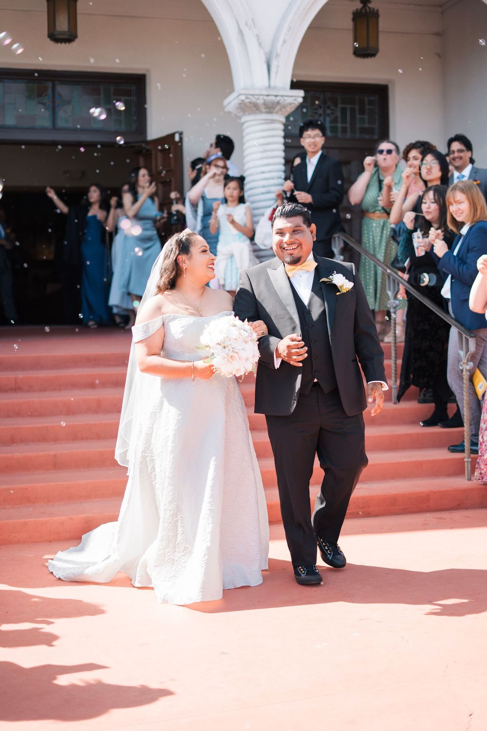 Husband and wife walk out of the ceremony to celebrate their marriage