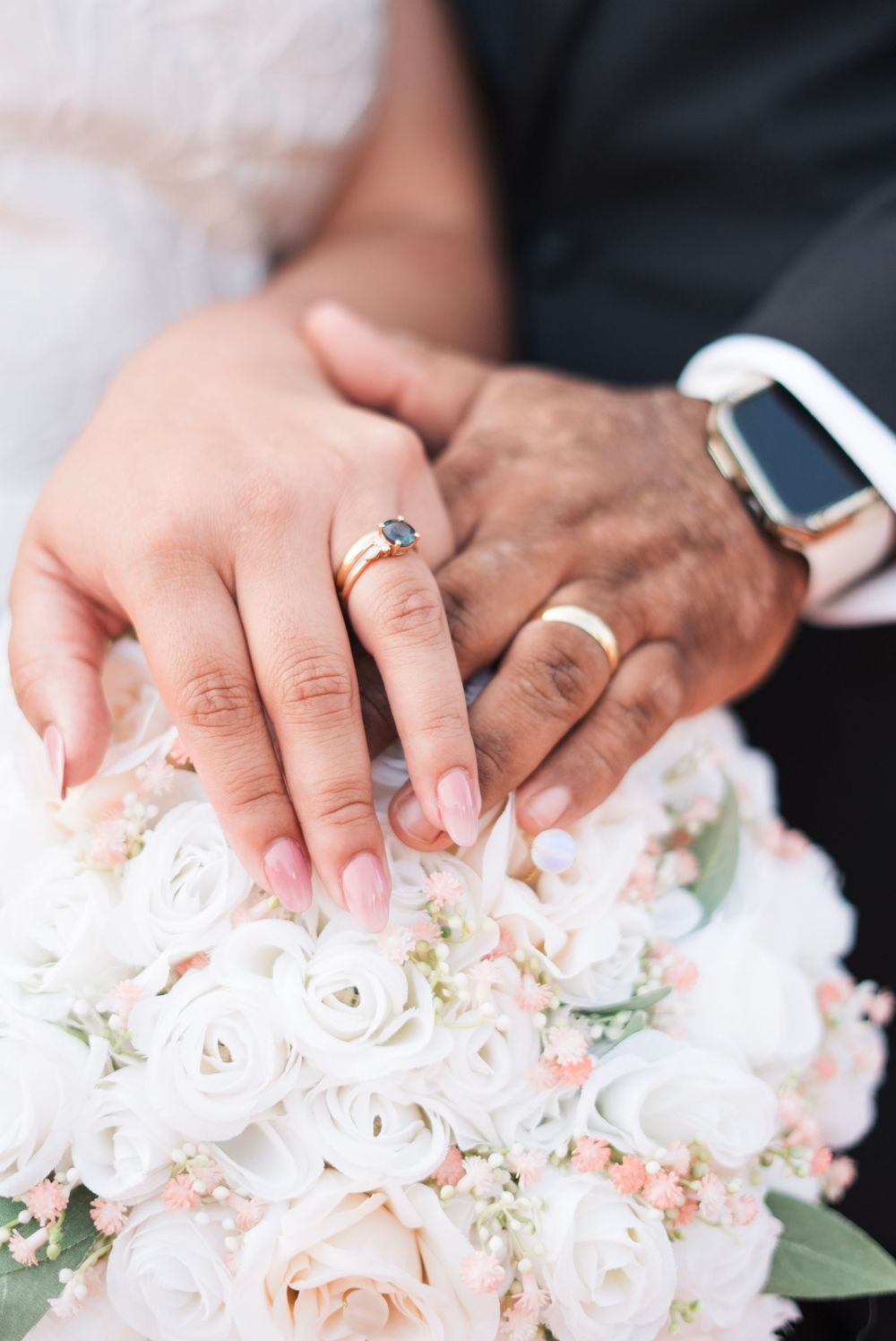 husband and wife show off their rings