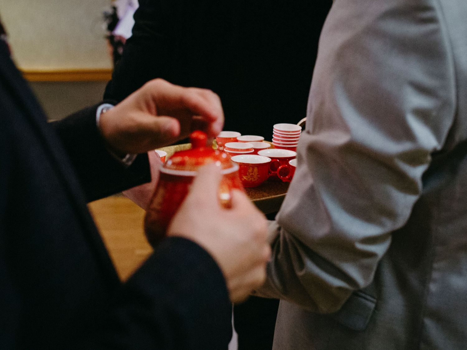 Two people holding red plastic cups at a social gathering.