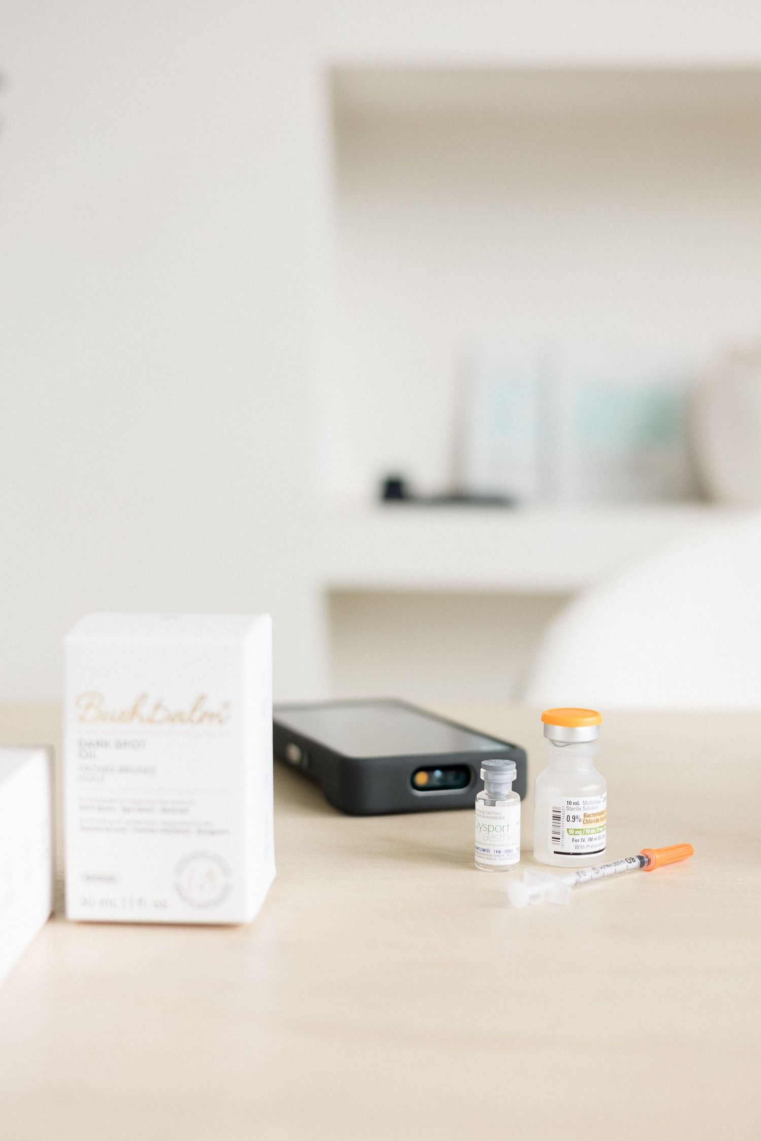 Minimal branding detail shot for a nurse injector of desk setup with notebook and coffee, styled for a modern business brand.