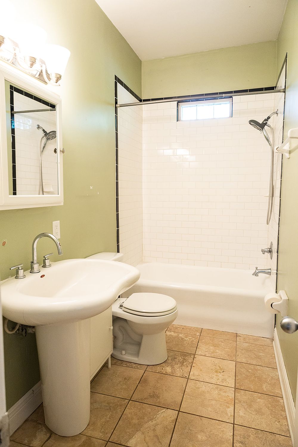 Modern bathroom interior with beige tile floor, white fixtures, and sage green walls showcasing multiple angles and views.