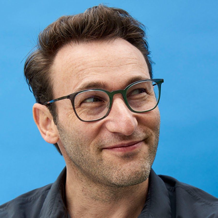 Close-up progression of someone with glasses smiling against a blue background, showing different expressions.