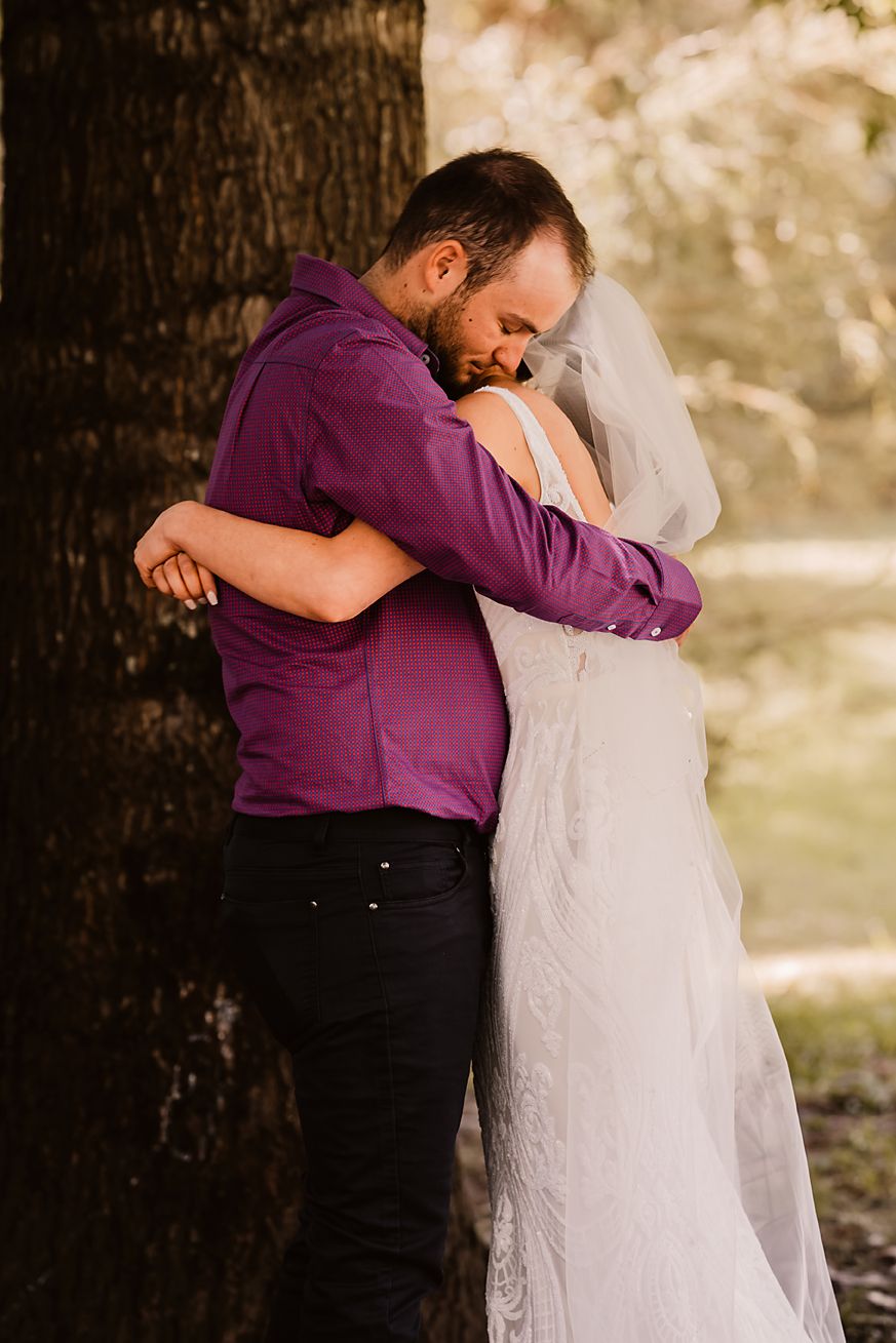 A romantic moment captured in a series of four photographs showing a couple embracing under a tree in purple and white attire.