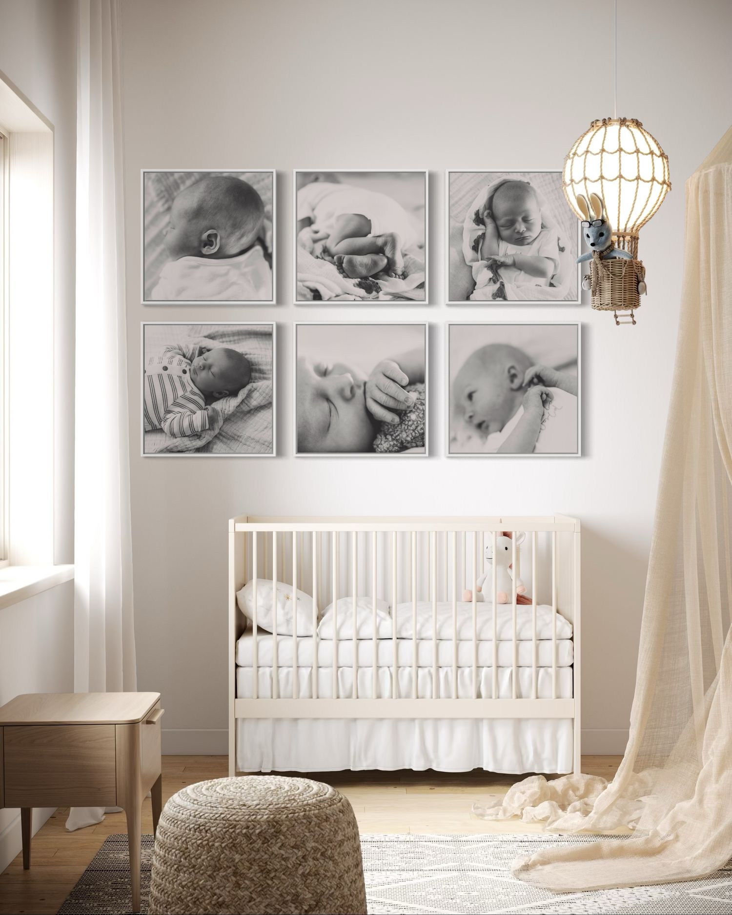 White nursery room decor features framed black and white baby photos, a round pendant lamp, and elegant crib with draped fabric.