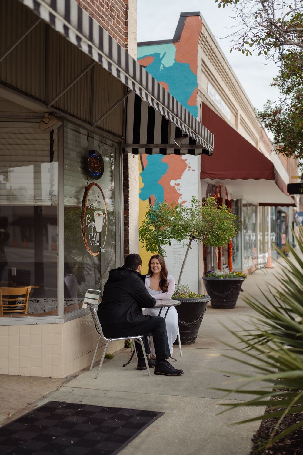 couple having coffee during engagement session downtown Conway,sc