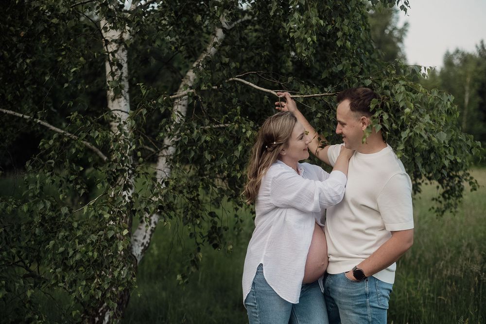 A couple sharing a playful moment together in a natural outdoor setting.