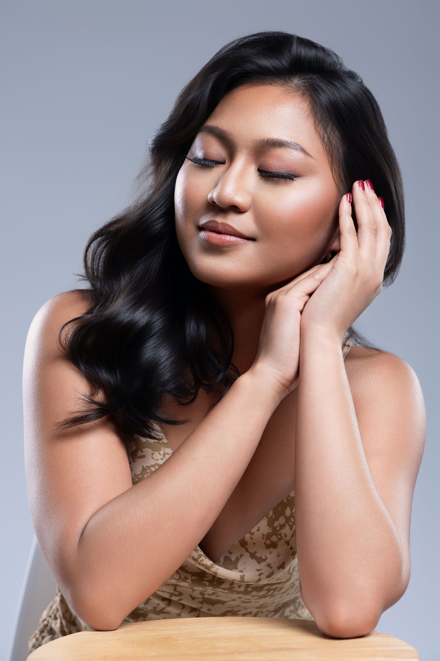 Elegant beauty portrait with flowing dark hair and natural makeup.