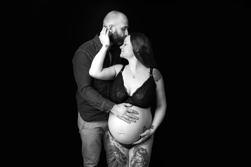 Intimate black and white maternity portraits with dramatic lighting.