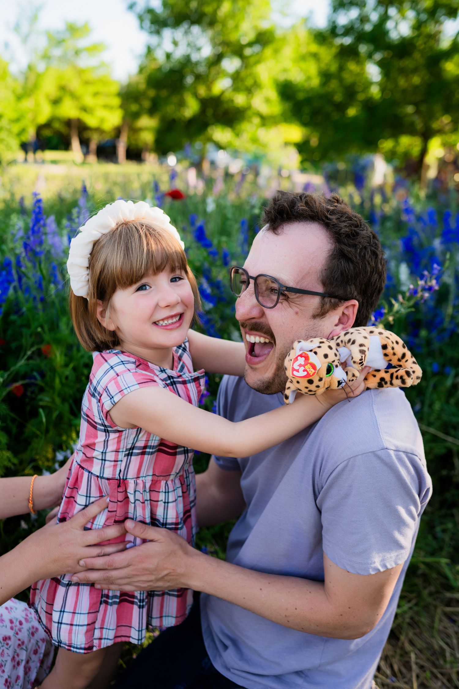 Dad and daughter during dallas area family mini session, dad kneeling to preschool aged daughters level
