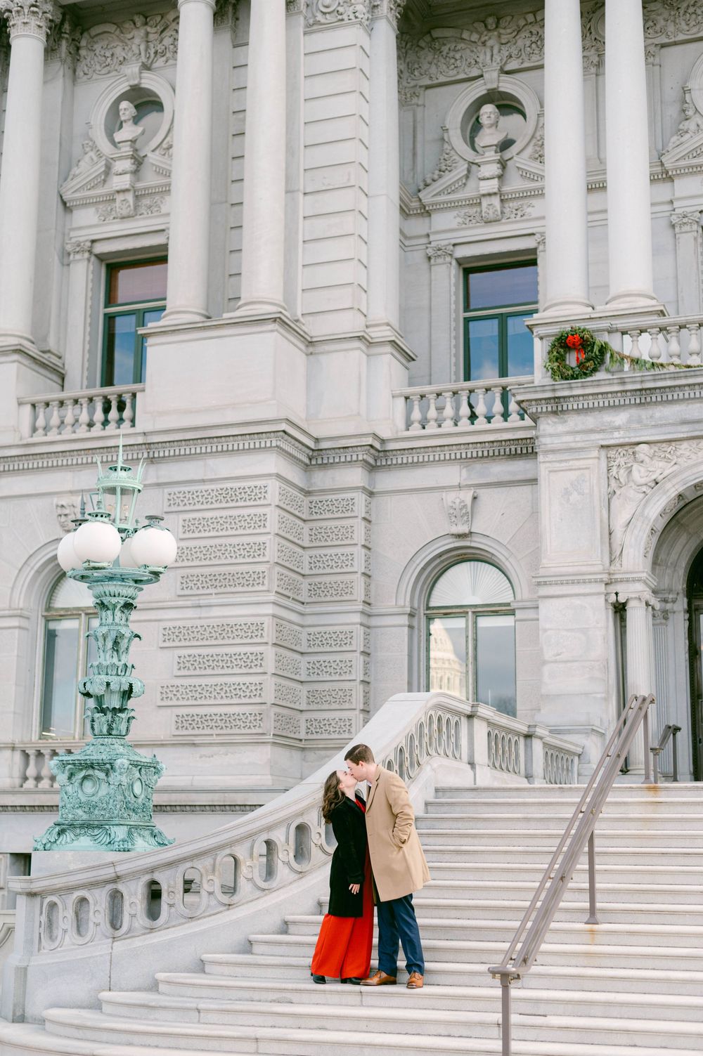 An elegant architectural shot of a historic building with ornate details and holiday wreaths.