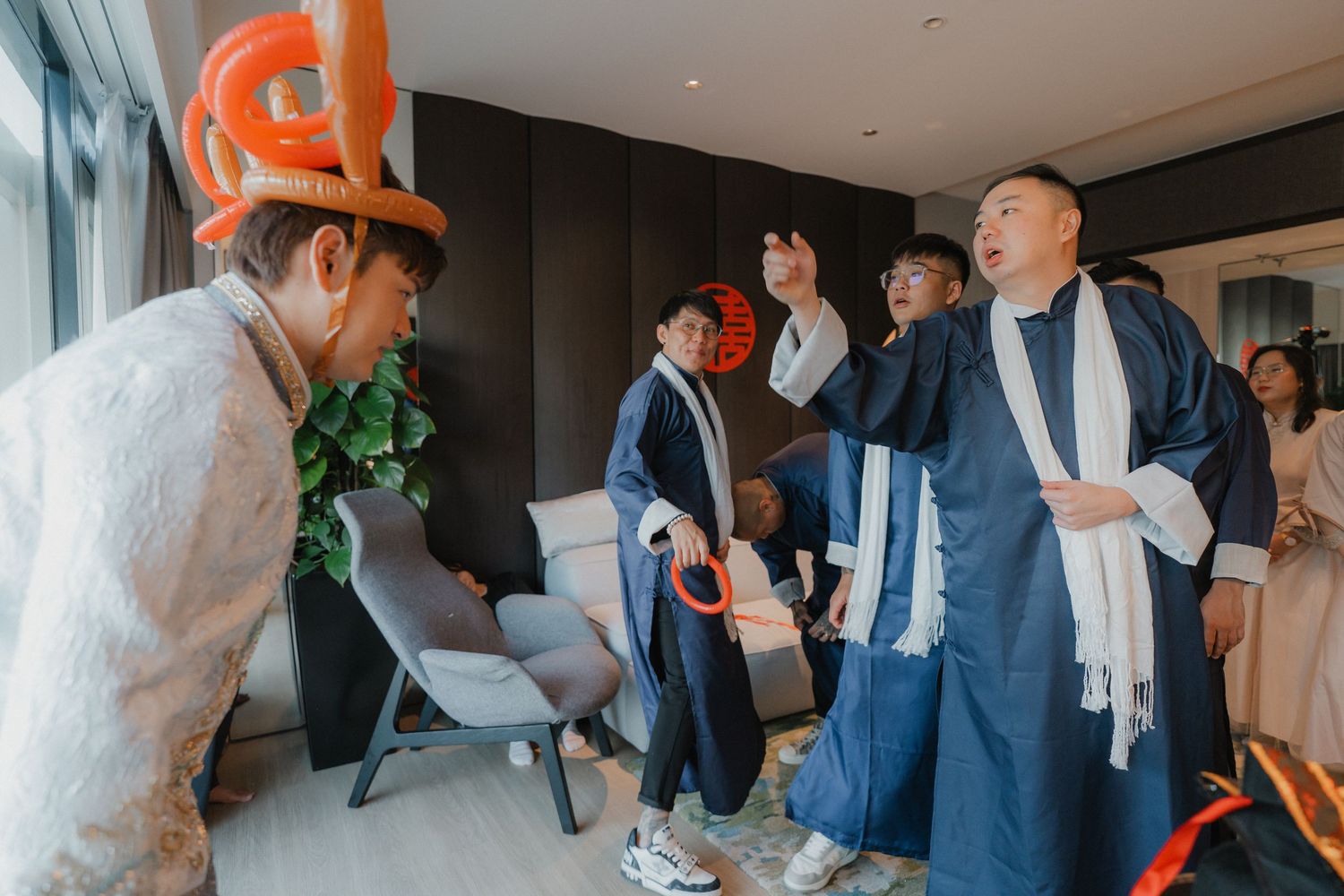 Wedding guests participating in celebration games in a bright indoor space.
