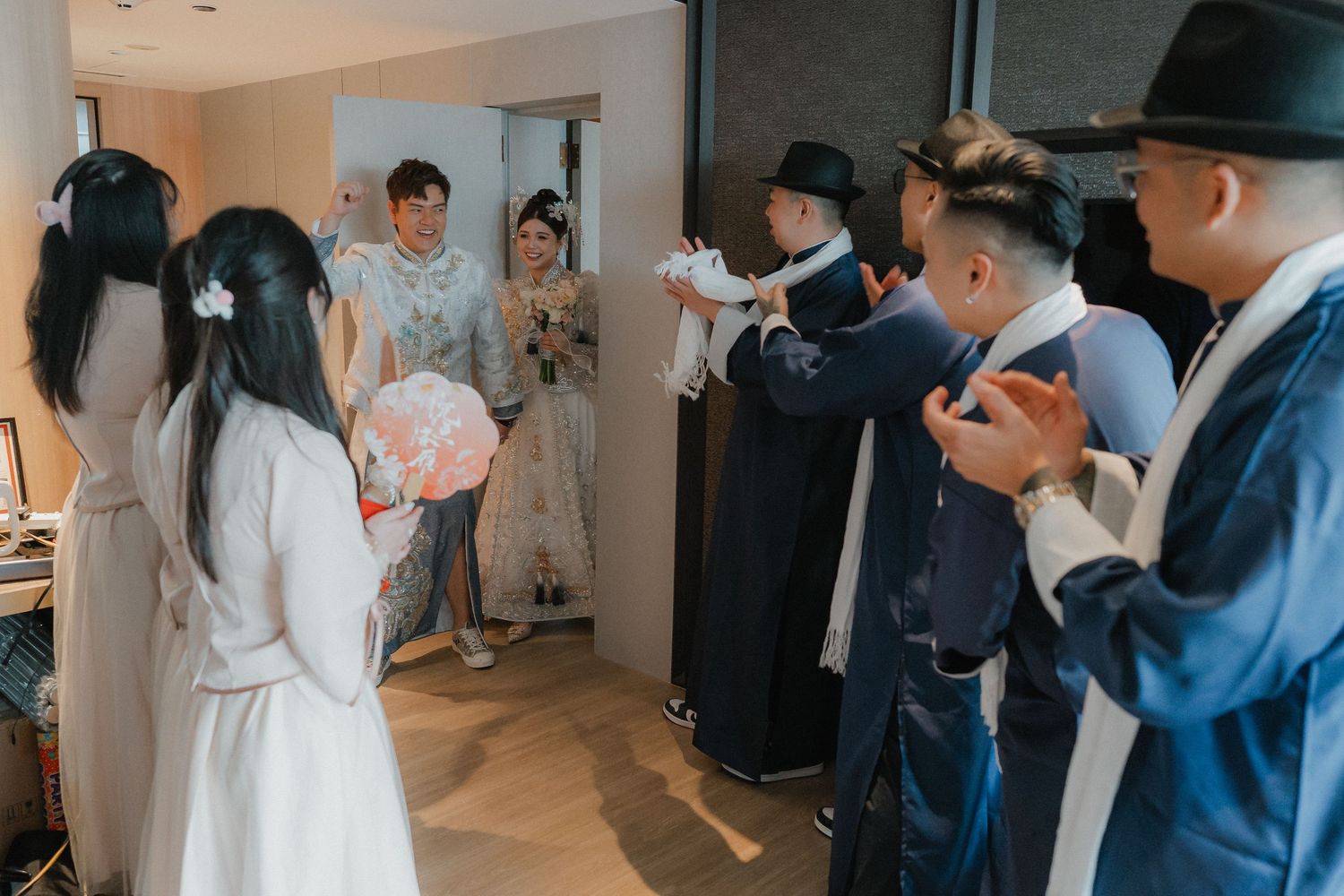 Wedding photographers capturing special moments during an indoor celebration.