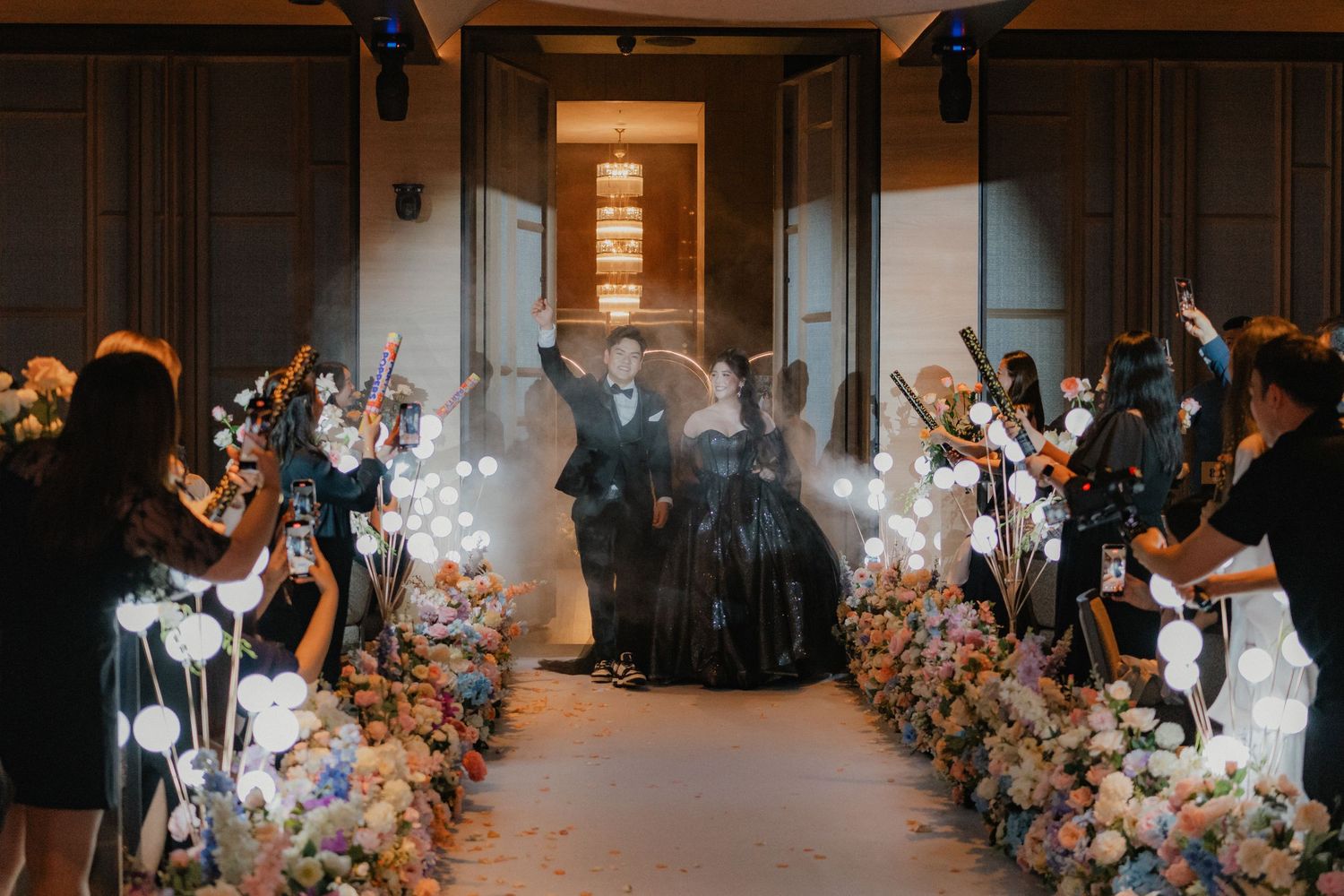 Wedding celebration venue with illuminated balloon decorations and floral arrangements.