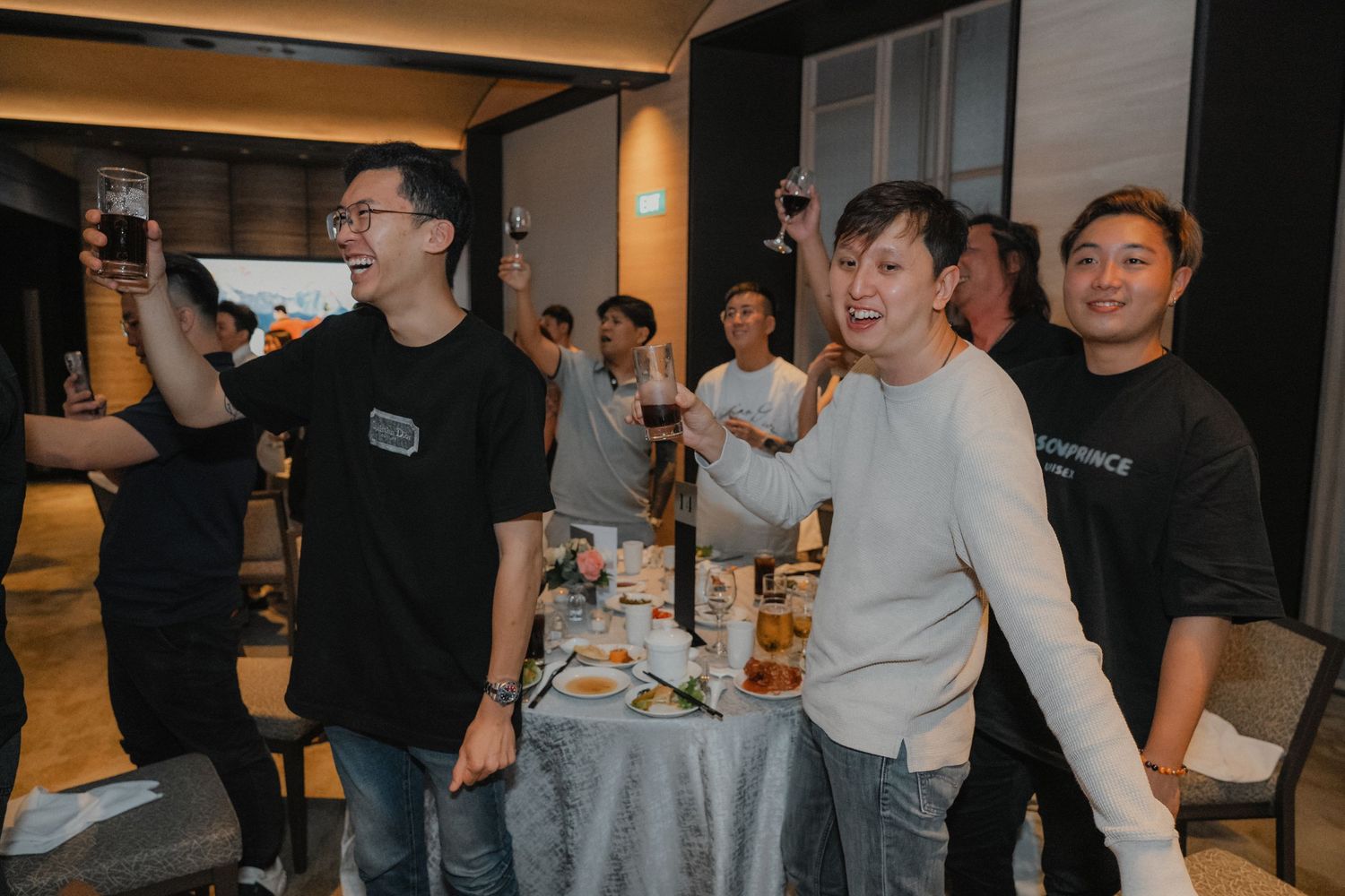 A group of people socializing at a casual networking event in a bright modern space with refreshments.