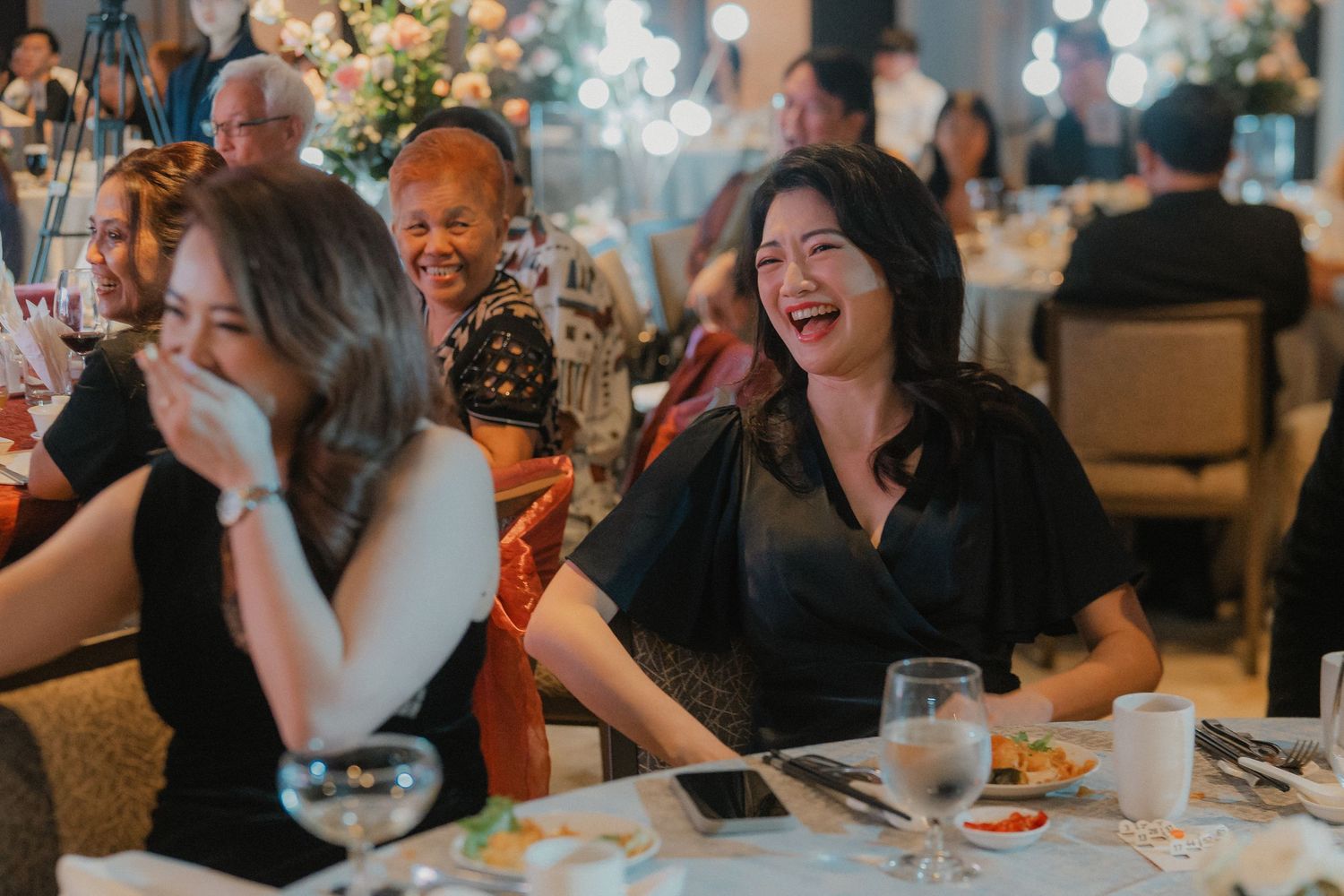 Wedding guests sharing laughs and enjoying themselves during the reception dinner.