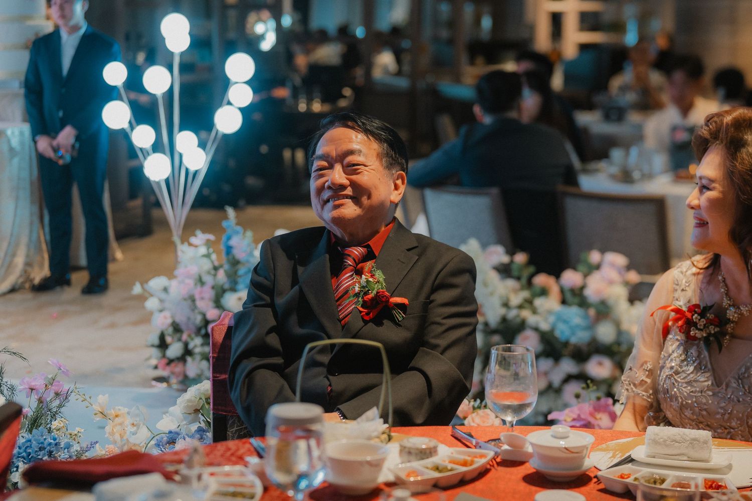 Guests enjoying a festive wedding reception with LED balloons creating a magical atmosphere.