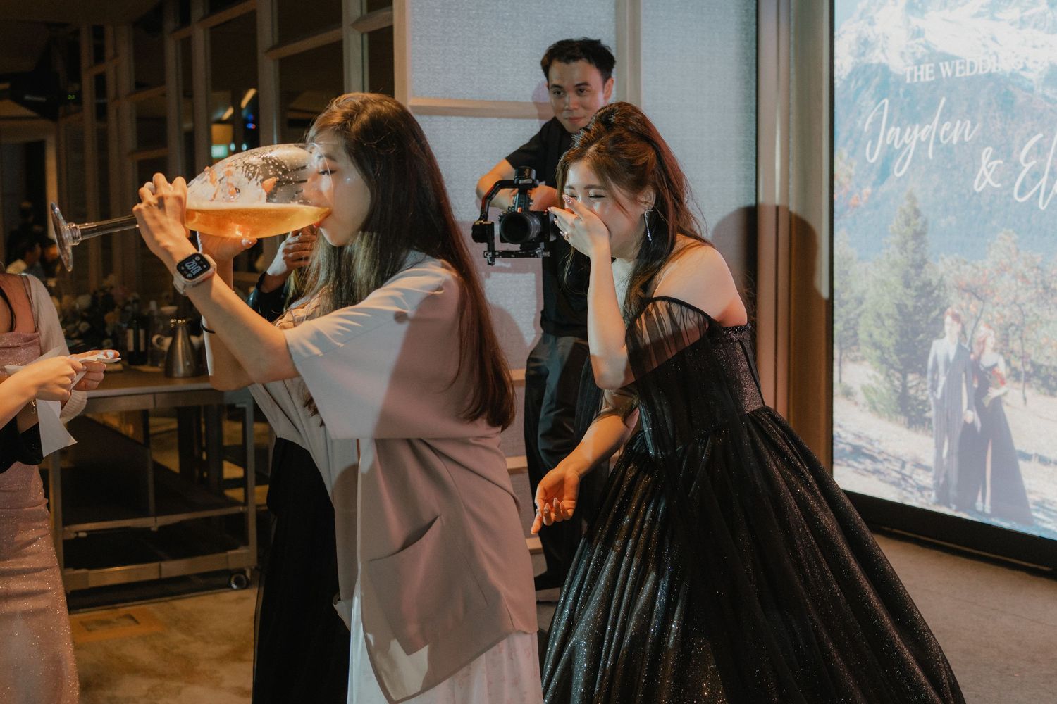 Wedding guests enjoy a group photo session during a reception celebration.