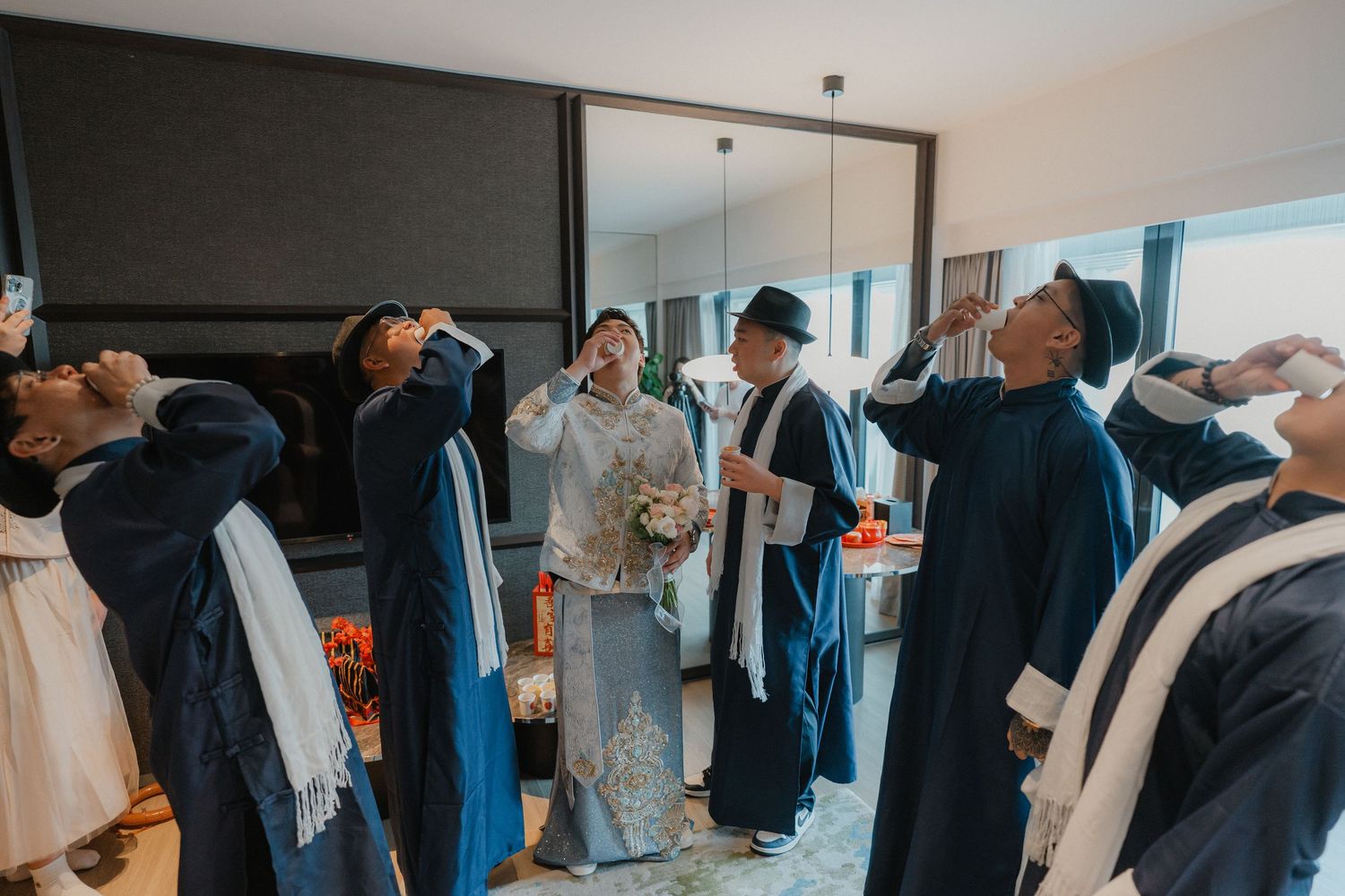 Clothes racks filled with formal suits and dress clothes in a bright showroom interior.