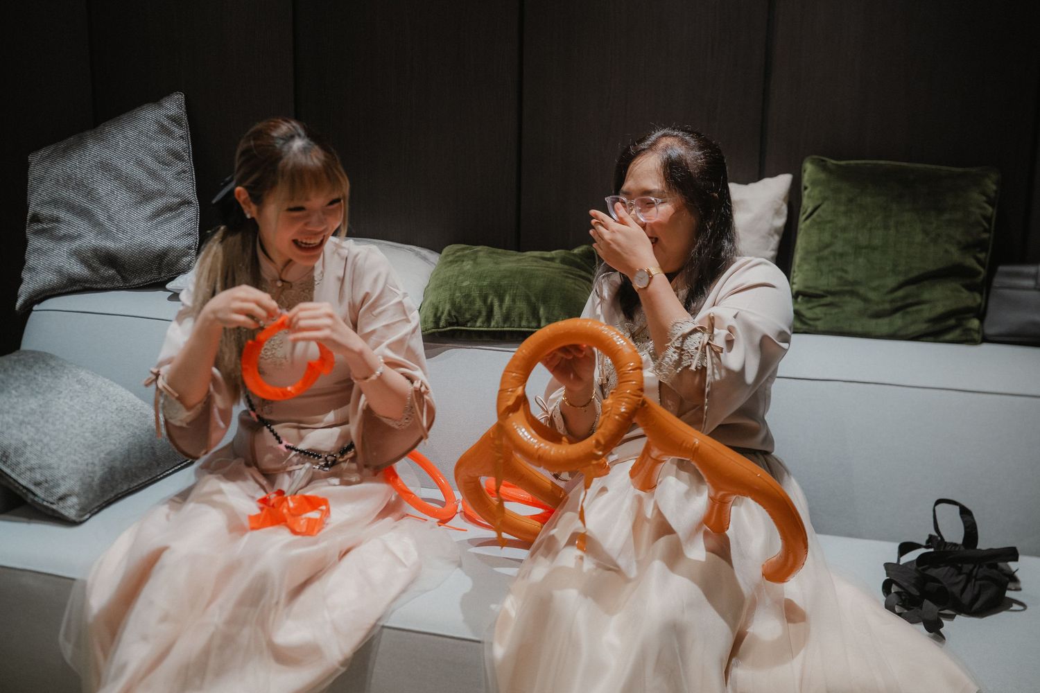 Traditional Chinese wedding games and activities being played with orange balloons.
