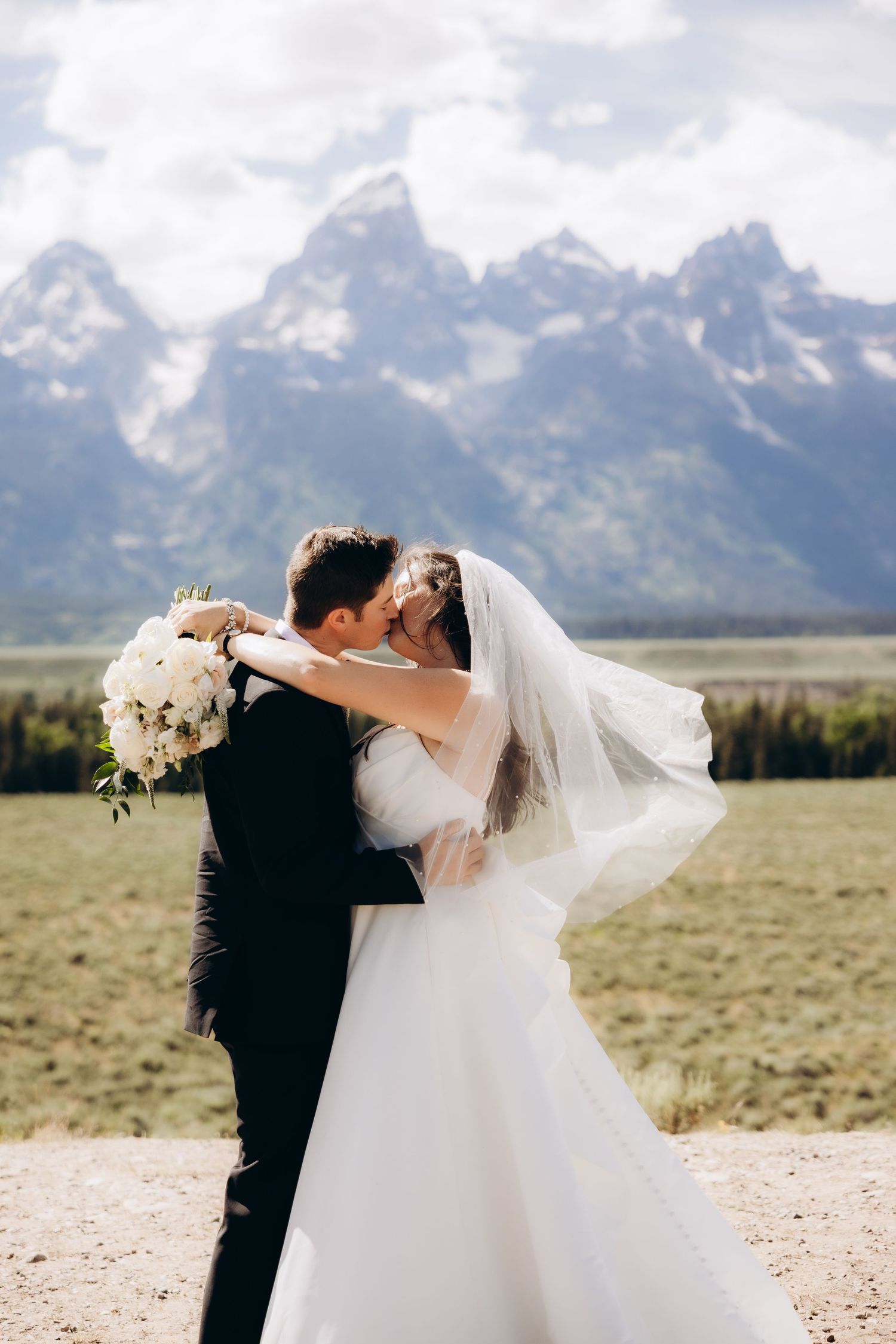 A romantic wedding photo sequence shows a couple dancing and dipping against the backdrop of majestic mountain peaks.