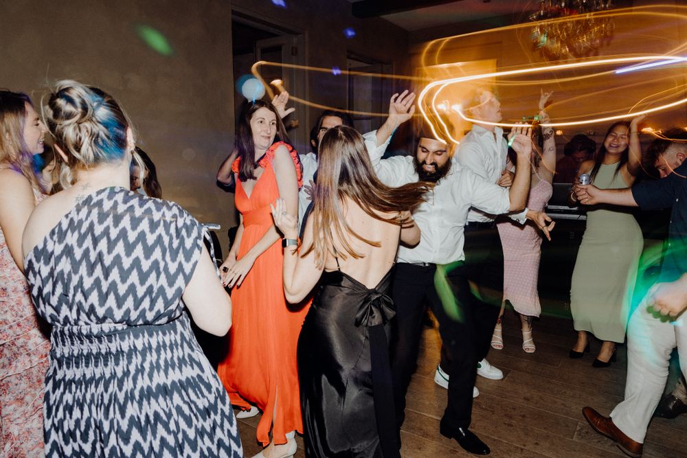 People dancing and enjoying themselves at a party, captured by Apertured Media Auckland Wedding Photographer.