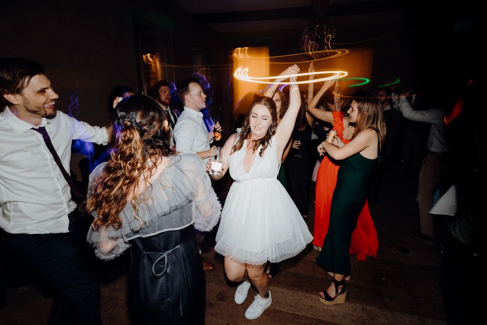 A lively dance party scene with the bride and her guests, captured by Apertured Media Auckland Wedding Photographer.