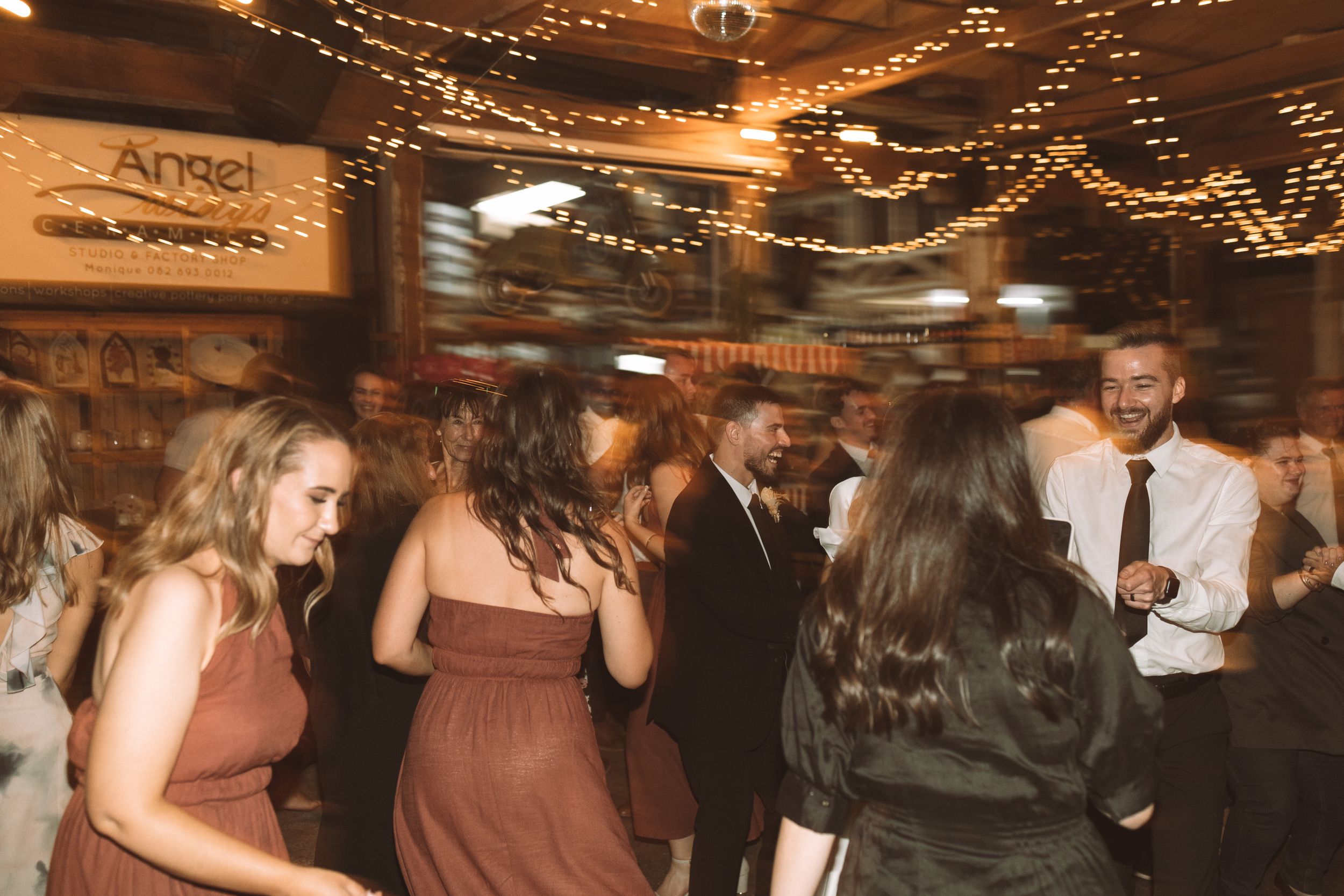Wedding reception venue with twinkling string lights creating a warm atmosphere.