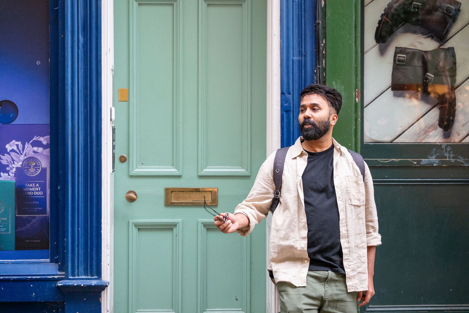 A series of five similar photos showing someone in a light vest standing in front of a mint green door.
