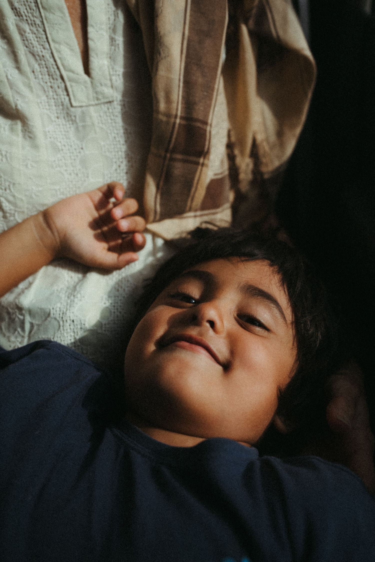 Dramatic lighting captures peaceful resting moments in a sequence of intimate portraits.
